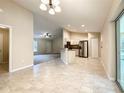 Open-concept kitchen and living room featuring modern appliances, tile flooring, and sliding glass doors at 4887 Sw 159Th Lane Rd, Ocala, FL 34473