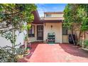 The cozy front porch features a decorative wreath and charming outdoor decor on the red brick patio at 940 Fenton Ln # 7, Lakeland, FL 33809