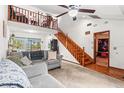 Comfortable living room featuring a wood staircase to loft and an entry into another room at 940 Fenton Ln # 7, Lakeland, FL 33809