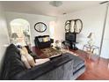 Cozy living room featuring hardwood floors, comfortable seating, and a large television at 7055 Heatherbrook Dr, Lakeland, FL 33809