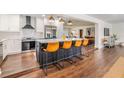 Modern kitchen features a large island with seating, stainless steel appliances, and stylish pendant lighting at 3120 S Polk Ave, Lakeland, FL 33803