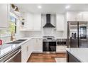 Bright kitchen with white cabinets, quartz countertops, stainless steel appliances, and herringbone tile backsplash at 3120 S Polk Ave, Lakeland, FL 33803