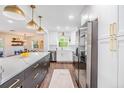 Open kitchen with a large island, stainless steel appliances, and view to the dining and living areas at 3120 S Polk Ave, Lakeland, FL 33803