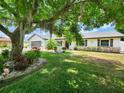 Beautifully landscaped front yard with mature shade tree enhances this single Gathering home's curb appeal at 4102 Stonehenge Rd, Mulberry, FL 33860