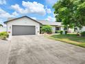Charming single Gathering home featuring a spacious driveway and well manicured lawn and landscaping at 4102 Stonehenge Rd, Mulberry, FL 33860