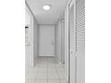 Bright hallway with white tile flooring, fresh gray paint, and convenient closet storage at 4160 Player Cir # 109, Orlando, FL 32808