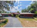 Inviting exterior showcasing a well-maintained home with a spacious driveway and lush greenery at 2292 Se 170Th Avenue Rd, Silver Springs, FL 34488