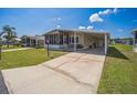 Exterior view showcasing a well-maintained lawn, carport, and appealing home design in a vibrant community at 97 Parson Dr, Winter Haven, FL 33884