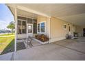 Home exterior with screened porch, carport, garden bed, bench, and welcoming entrance at 97 Parson Dr, Winter Haven, FL 33884