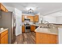 Functional kitchen featuring stainless steel appliances, wood cabinets, and wood-look flooring at 9700 Sw 196 Circle, Dunnellon, FL 34432
