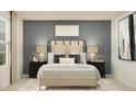 Inviting bedroom showcasing a plush bed, two matching nightstands, and serene blue accent wall at 2105 Albatross Nest Dr, Bartow, FL 33830