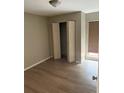 Cozy bedroom features wood-look floors, closet, and a window offering natural light at 2123 Woodburn S Loop, Lakeland, FL 33813