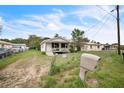 Modest home with front yard, chain link fence, and mailbox at 303 Clayton Rd, Auburndale, FL 33823