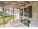 Covered front porch with seating, a view of the neighborhood, and access to the front door at 303 Clayton Rd, Auburndale, FL 33823