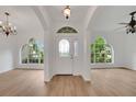 Bright entryway featuring wood floors and arched windows at 3897 Beacon Ridge Way, Clermont, FL 34711