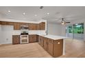 Well-equipped kitchen with stainless steel appliances and wood cabinets at 3897 Beacon Ridge Way, Clermont, FL 34711