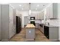 Modern kitchen featuring gray cabinets, butcher block island, and stainless steel appliances at 722 Swaying Palm Dr, Apopka, FL 32712