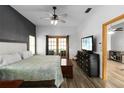 Spacious main bedroom with French doors, a large bed and a ceiling fan at 722 Swaying Palm Dr, Apopka, FL 32712