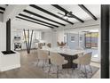 Dining room with a marble table, designer chairs, and view into the renovated, modern kitchen at 837 E Edgewood Dr, Lakeland, FL 33803