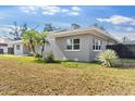 Single-story home featuring a gray brick exterior, modern windows, and beautiful landscaping at 837 E Edgewood Dr, Lakeland, FL 33803