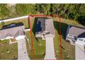 Aerial view of a single-Gathering home with a large lot, driveway, and surrounding neighborhood at 27 Perch Dr, Kissimmee, FL 34759