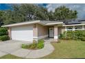Close up of front entrance, showing the front door, landscaped yard and two car garage at 4462 Iris S St, Lakeland, FL 33813