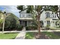 Charming two-story home with a well-maintained lawn and front garden, complemented by mature trees and a paved walkway at 7810 Whitemarsh Way, Reunion, FL 34747
