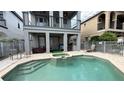 Resort style pool area featuring a spa, putting green, covered patio, and fenced yard for ideal outdoor enjoyment at 7810 Whitemarsh Way, Reunion, FL 34747
