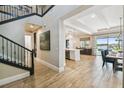 Inviting foyer with a staircase flowing into an open-concept living space and elegant dining area at 9080 Morgana Ct, Winter Garden, FL 34787