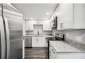 This modern kitchen is updated with stainless steel appliances, granite countertops and modern white cabinetry at 1022 Baycrest Dr, Lakeland, FL 33805