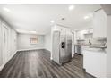 Open-concept kitchen featuring stainless steel appliances and sleek cabinetry, seamlessly flowing into the living area at 1022 Baycrest Dr, Lakeland, FL 33805