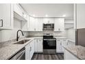 Modern kitchen with stainless steel appliances, granite countertops and stylish black fixtures at 1022 Baycrest Dr, Lakeland, FL 33805