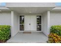 Welcoming front entrance with double doors, sidelight windows, and lush landscaping at 107 Elm S Sq, Lakeland, FL 33813