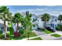 Attractive two-story home featuring a paved driveway, well-maintained lawn, and mature trees at 1423 Bunker Dr, Davenport, FL 33896