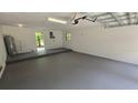 Spacious two car garage with concrete block walls and a side entrance door at 3115 Lake Arnold Pl, Orlando, FL 32806