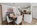 Charming dining room adjacent to kitchen, with a wooden table and stylish chairs at 731 Sugar Bay Way # 205, Lake Mary, FL 32746