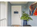 A welcoming entrance with a white door and blue 'Home Sweet Home' decor at 731 Sugar Bay Way # 205, Lake Mary, FL 32746