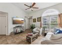 Bright living room featuring tiled floors, arch window, and modern decor at 731 Sugar Bay Way # 205, Lake Mary, FL 32746