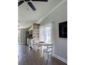 Dining area with white table and chairs, wood accent wall, and natural light at 85 Heather Point Ct # 850, New Smyrna Beach, FL 32169