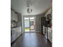 Modern kitchen with stainless steel appliances, grey cabinets, and sliding glass doors to outdoor space at 85 Heather Point Ct # 850, New Smyrna Beach, FL 32169
