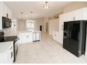 Modern kitchen featuring white cabinets, stainless steel appliances, and a breakfast bar at 1510 Avleigh Cir, Orlando, FL 32824