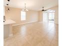 Open-concept living area with tile floors, ceiling fans and sliding glass doors at 1510 Avleigh Cir, Orlando, FL 32824
