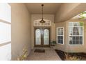 Inviting entrance with double doors, sidelights, and a covered porch, creating a grand welcome at 433 Woodcrest St, Winter Springs, FL 32708