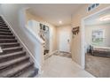 Bright foyer with stairway, built-in storage, and access to another room at 5660 Keaton Springs Dr, Lakeland, FL 33811