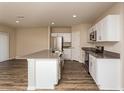 Open-concept kitchen with white cabinets, stainless steel appliances, and a large island with seating at 770 Ambleside Dr, Haines City, FL 33844