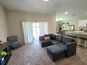 Open-concept living room with a gray sectional sofa and access to the dining area at 1368 Axel Cir, Winter Haven, FL 33880