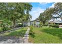 Quaint single-story home with well-maintained lawn, inviting walkway, and decorative plants at 306 Avenue A E, Winter Haven, FL 33880