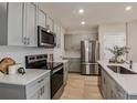 Stylish kitchen featuring stainless steel appliances, gray cabinets, and an island with countertop at 3759 King Hill Dr, Haines City, FL 33844