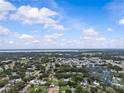 Aerial view of a suburban neighborhood with mature trees and lush landscaping on a sunny day at 4003 Prairie Bend Ln, Lakeland, FL 33812