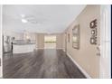 Spacious living area boasting modern flooring, neutral walls and ample natural light, offering a blank canvas at 647 San Pedro Dr, Lady Lake, FL 32159